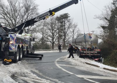 Sullivan's Towing & Recovery overturning an oil truck in the wintertime