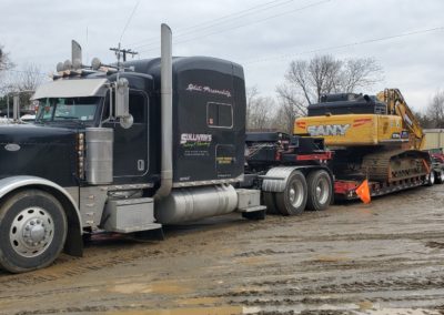 Sullivan's Towing & Recovery, LLC towing a construction digger
