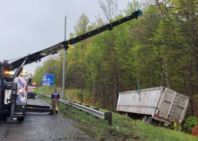 Semi truck on the side of the highway being recovered by Sullivan's Towing & Recovery