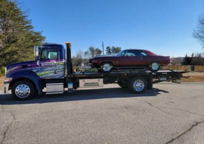 Sullivan's Towing & Recovery, LLC flatbed with a mustang being towed