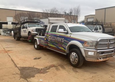 Sullivan's Towing & Recovery, LLC towing an industrial truck