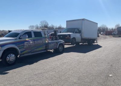 Sullivan's Towing & Recovery, LLC tow truck towing a white truck