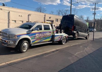 Sullivan's Towing & Recovery, LLC truck towing a van